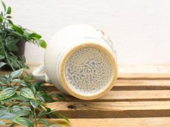 Artisan ceramic mug with vibrant designs, showcasing craftsmanship and unique charm.