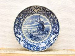 Beautiful blue and white decorative plate featuring a windmill and charming village scene.