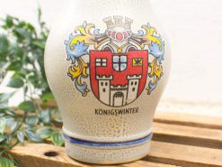 Elegant Königswinter ceramic jug showcasing a vibrant coat of arms and artisanal craftsmanship.