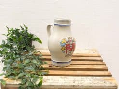 Vintage ceramic pitcher with Königsberg emblem, perfect for decor and rustic charm.