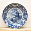 Beautiful blue and white decorative plate featuring a windmill and charming village scene.