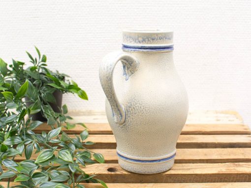 Elegant vintage ceramic jug with blue accents and textured design, perfect for rustic decor.