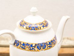 Elegant porcelain teapot with blue and gold accents, perfect for refined tea settings.