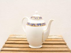 Elegant porcelain teapot with floral designs and gold accents, perfect for stylish tea moments.