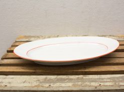 Elegant white serving platter with orange rim, perfect for any dining occasion.