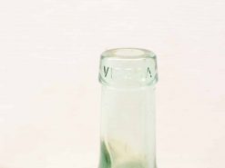 Vintage green glass bottle with VIRGINIA engraving, elegant design for collectors and enthusiasts.