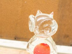 Charming vintage glass pig figurine with colorful base, perfect decorative accent for any collection.