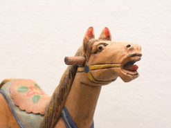 Intricately carved wooden horse head, a charming piece of folk art and decor.