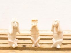 Wooden Three Wise Monkeys sculptures embodying Hears no evil, Sees no evil, Speaks no evil.