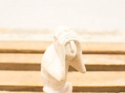 Emotive wooden sculpture of a figure in distress, beautifully crafted for artistic reflection.