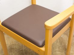 Comfortable wooden chair with deep brown cushion, ideal for various interior settings.