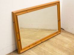 Elegant light wood mirror with a rustic frame, ideal for any interior style.