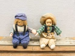 Charming vintage dolls in blue and green, perfect for collectors or playful companions.