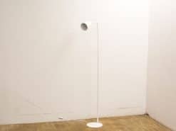 Elegant minimalist white floor lamp enhancing modern interiors with sleek design and functional lighting.