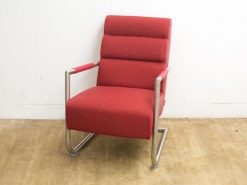 Modern red lounge chair with a sleek design, providing comfort and style for any space.