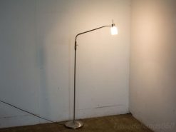 Sleek modern floor lamp with translucent glass shade, ideal for stylish interiors and reading nooks.