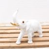 Elegant porcelain elephant figurine with gold accents, perfect for any décor style.