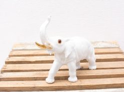 Elegant porcelain elephant figurine with gold accents, perfect for any décor style.