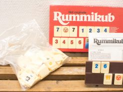 Classic Rummikub game set with colorful tiles, instructions, and holder for family fun nights.