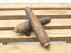 Rusty metal cones with pine cone texture, perfect for rustic decor and historical interest.