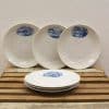 Elegant vintage ceramic plates with blue illustrations, perfect for rustic table settings.