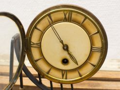 Antique clock with gold accents and Roman numerals, embodying timeless elegance and vintage charm.