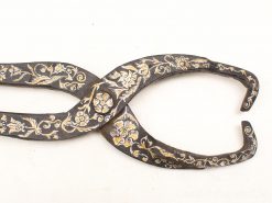 Elegant vintage metal tongs with floral engravings and butterfly design, perfect for décor and usability.