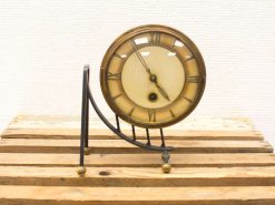 Elegant vintage brass desk clock with Roman numerals, perfect for stylish decor or workspace.