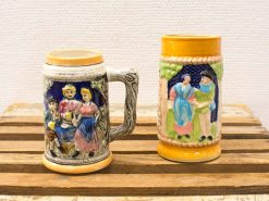 Colorful vintage ceramic mugs featuring cultural designs and intricate craftsmanship, perfect for collections.