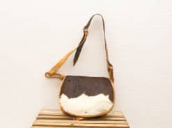 Unique vintage leather crossbody bag with fur, featuring stylish design and adjustable strap.