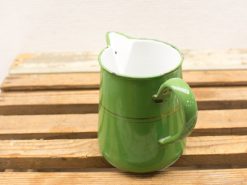 Vintage green enamel pitcher with gold accents, perfect for rustic decor.