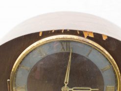 Antique wooden clock with Roman numerals and elegant gold detailing, showcasing vintage craftsmanship.