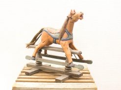 Elegant vintage wooden rocking horse with charming floral motifs, perfect for playrooms and nurseries.