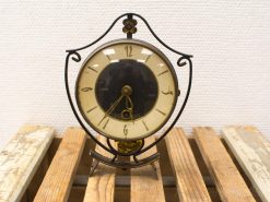 Elegant vintage wrought iron clock with pendulum, showcasing timeless craftsmanship and classic design.