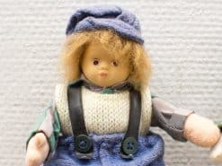 Charming vintage doll with playful attire and endearing features, perfect for collectors and nostalgia lovers.