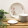 Elegant vintage porcelain plates with floral patterns, perfect for refined dining and home decor.