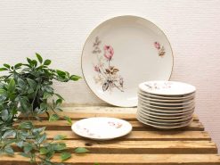 Elegant vintage porcelain plates with floral patterns, perfect for refined dining and home decor.