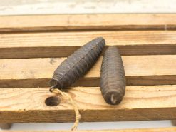 Vintage ribbed oval objects on rustic wood, evoking traditional craftsmanship and timeless elegance.