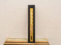 Vintage dual-scale thermometer in yellow and black, perfect for retro home decor enthusiasts.