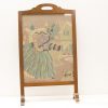 Charming woman with camera in vintage village scene, perfect for nostalgic home decor.