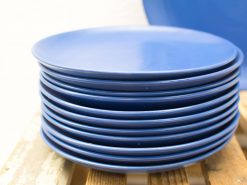 Glossy blue plates stack, perfect for elegant dining and stylish decor.