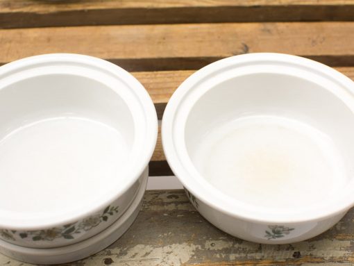 Elegant ceramic bowls, one floral and pristine, the other worn, perfect for any table setting.