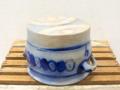 Handcrafted ceramic pot with vibrant blue patterns and elegant handles for functional décor.