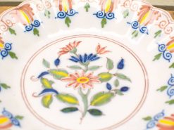 Elegant ceramic plate with intricate floral design and vibrant pastel colors. Perfect for decor.