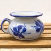 Charming handcrafted ceramic pot with blue floral designs, perfect for flowers or decor.