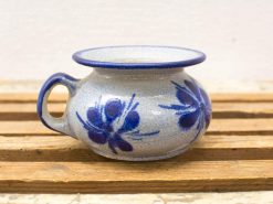 Charming handcrafted ceramic pot with blue floral designs, perfect for flowers or decor.