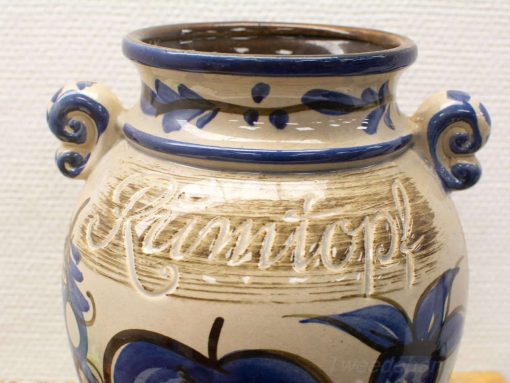 Elegant ceramic vase with blue floral patterns and spiral handles, perfect for home decor.