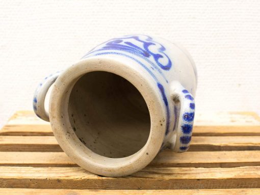 Handcrafted ceramic jug with blue designs on cream, perfect for decor or practical use.