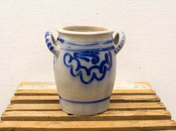 Handcrafted cream ceramic pot with blue swirl design and dual handles for rustic decor.