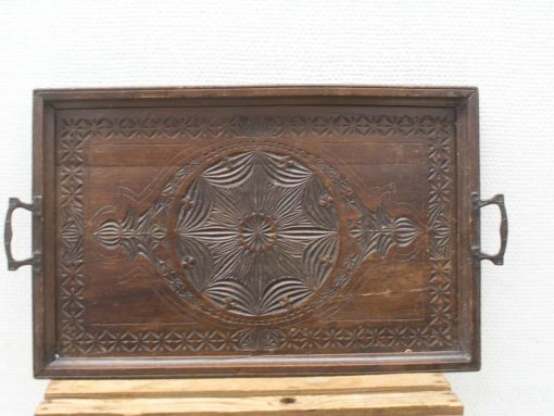 Intricately carved wooden serving tray with elegant design and rich dark finish.